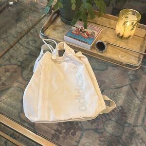 Adidas cream backpack with adjustable drawstring top and backpack straps